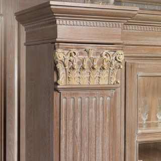 Classic bookcase unit for modular wall, detail of a column with carved and golden capital