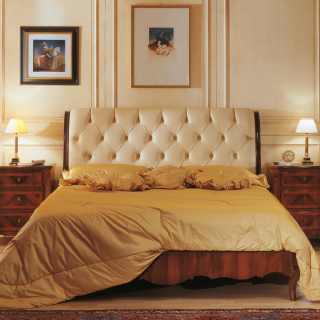 Luxury classic bed with capitonné leather headboard, walnut night table, antique finish